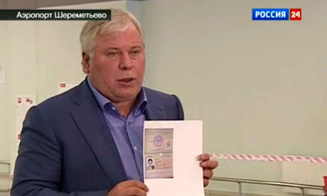 Anatoly Kucherena, Edward Snowden&apos;s lawyer, shows a copy of a temporary document allowing 