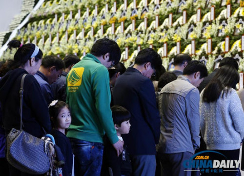 4月27日，在韩国安山一处临时客轮遇难者纪念堂附近，民众前来哀悼这些逝去的人。