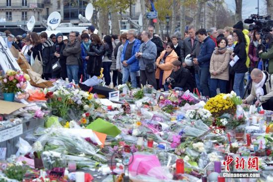 当地时间11月16日，法国举国哀悼巴黎恐怖袭击的遇难者。巴黎共和国广场上聚集了大批自发前来悼念的民众。 龙剑武 摄